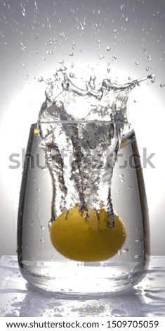 lemon falls into a vessel with water, spray and pueyri