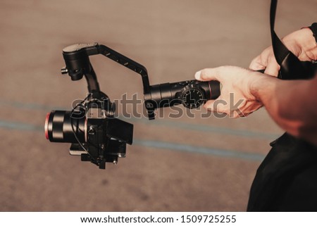Professional record. Videography. Hand with cinematic digital equipment. Record device. Camera stabilizer