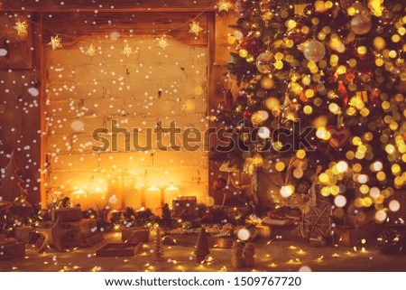 Magical Christmas composition, decorated fireplace with wooden mantelpiece, lit up Christmas tree with baubles ornaments, stars, lights, candles, toned, snow imitation, bokeh, selective focus