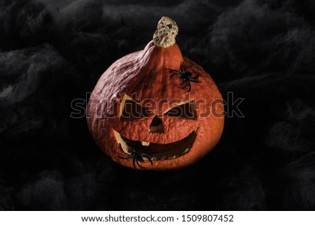 spooky carved Halloween pumpkin on black background