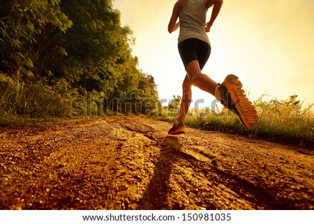 Young lady running on a rural road Royalty-Free Stock Photo #150981035