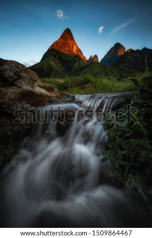 Flowing of waterfall infront of Fansipan peak , High mountain in Vietnam