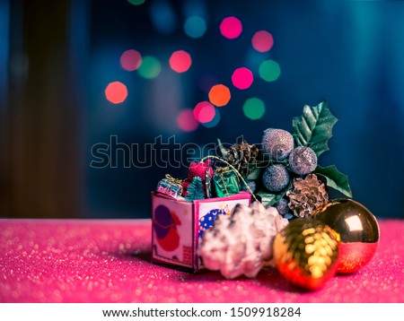 Christmas card with Christmas decorations and multicolor lights on blue background