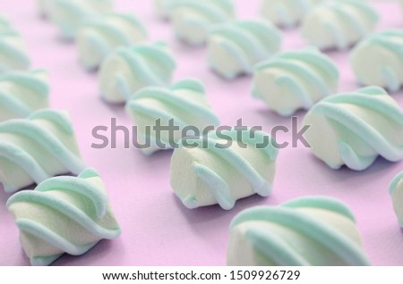 Colorful marshmallow laid out on pink paper background