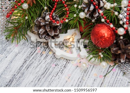 Christmas fir branches, cones, toys, garland on a vintage wooden background