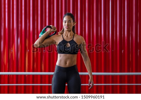 beautiful girl holding a kettlebell at the gym
