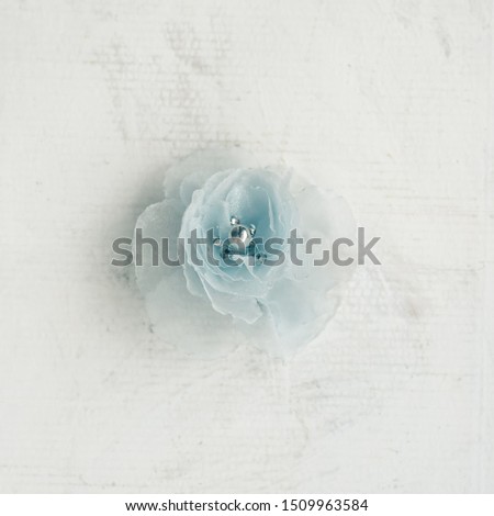 Pastel blue color delicate soft fabric flower in vintage style for background. Retro style postcard in white and blue color.