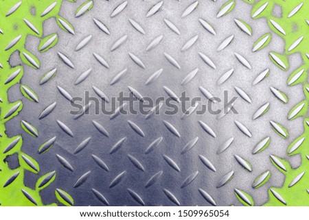 
old wiped polished metal diamond plate the floor is painted in bright green color, background. industrialization concept