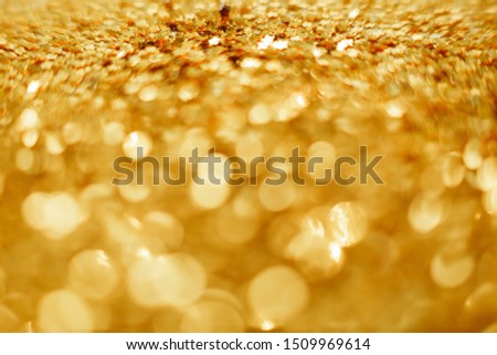 Gold Christmas background from sparkles. Blurred abstract textures.