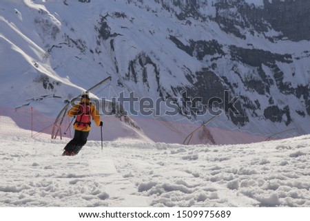 Skier down the mountain. Skier over slope
