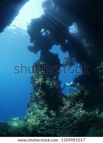 scuba diver exploring caves underwater cave diving blue water 