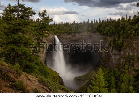 Beautiful View of a waterfall, Helmcken Falls, in the Canadian Mountain Landscape during a sunny and cloudy day. Taken in Wells Gray Provincial Park, near Clearwater, BC, Canada.