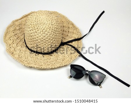 Fashion cream straw woven hat strap with black line stripe and black glasses on white background