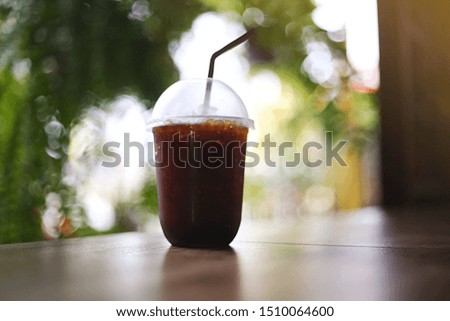 Close up Ice black coffee on wood table