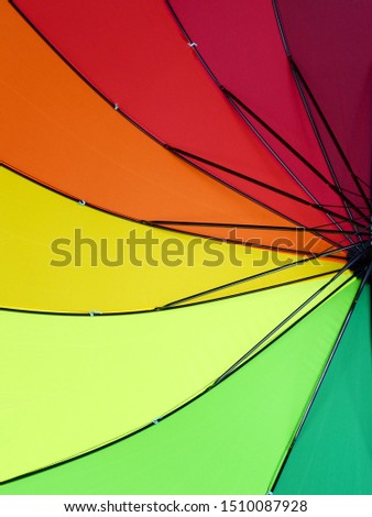 Under the umbrella of colorful spread, multicolor fabric background