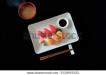 Salmon and Tuna Sushi with Miso Soup Soy Sauce and Chopsticks, Flat Lay photo