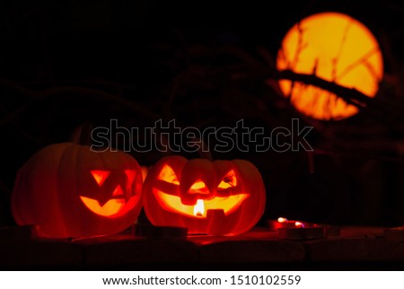 pumpkin background Halloween. happy Spooky scary pumpkin head or jack lantern smiley funny horror magic face soft focus glow in the dark background with bokeh of cross shape. October Halloween design