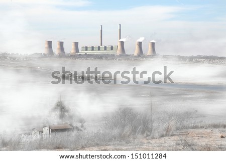 Air pollution in a coal rich South Africa.  Chimneys billowing with toxic smoke on a early winters morning.  Royalty-Free Stock Photo #151011284