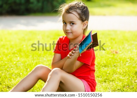 Beautiful little girl chooses a color of paint on color palette