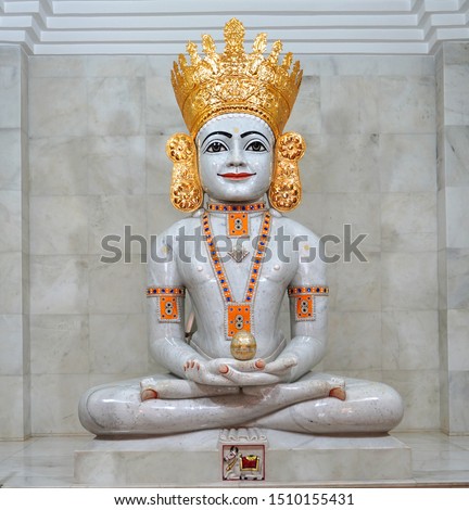 Indian Hindu god young Mahavir with golden crown, seating on bench and blessing with spiritual. Royalty-Free Stock Photo #1510155431