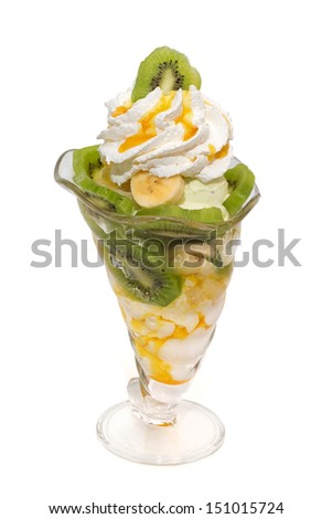 Fruit salad with icecream, cream, topping isolated