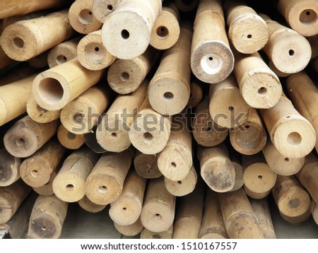 Long pieces of bamboo  laid horizontally. Uneven arrangement of wood logs 