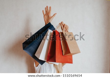 Happy woman holding in hand shopping package. Paper bag. Sale in store. Beautiful young girl in fashion shop. Customer buy present. Black friday sale. Holiday special offer, discount. Female in market