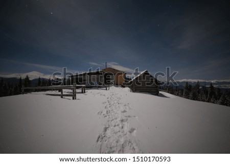 Wonderful night views of the Carpathian winter mountains with millions of stars in the sky and beautiful scenery