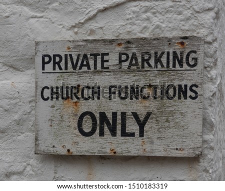 "Private Parking, Church Functions Only" Sign Attached to a Church Wall in the Seaside Town of Marazion on the South Coast of Cornwall, England, UK