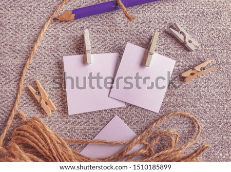 A Blank Pieces of Note Papers and Wood Clothespins on the Cloth