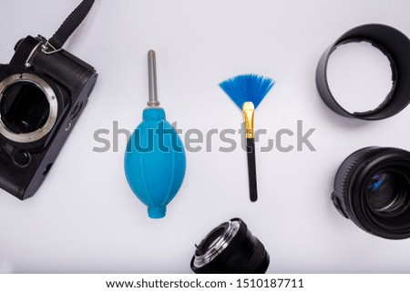 Cleaning brush and dust dryer for Camera and lens. isolate with white background on top view.