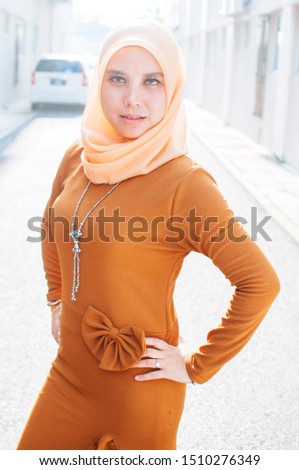 Young beautiful fashion hijab women posing with urban city background