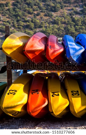 Active kayaking by the sea among the mountains. Colored boat parking