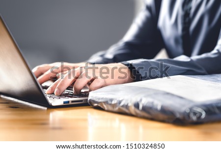 Return package after free shipping for online order. Wrong product from internet. Man writing complaint, claim or reclamation with laptop. Bad customer feedback. Shopping for clothes, jeans or shirt. Royalty-Free Stock Photo #1510324850