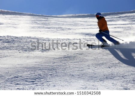 Sporty skier riding the slope 