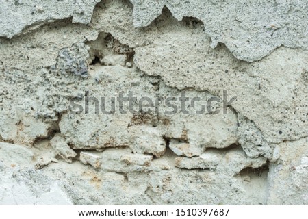 A view of an old textured wall covered with sand-cement plaster