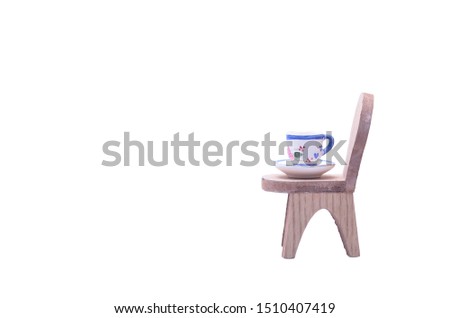 Empty coffee cup on a chair isolated on white background