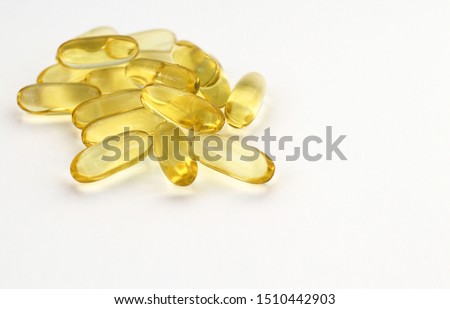 Top view on yellow multivitamin capsules on a light background