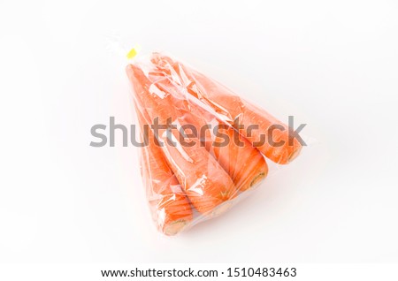 fresh Carrot in plastic bag on white background Royalty-Free Stock Photo #1510483463