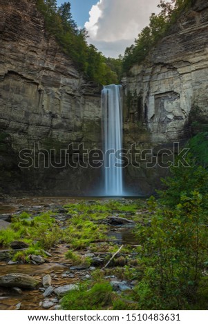 Taughannock Falls is a 215-foot (66 m) plunge waterfall, that is the highest single-drop waterfall east of the Rocky Mountains, located about 10 miles north of Ithaca in New York State, USA.