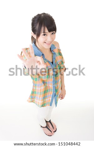 Young pretty asian woman showing OK sign. Isolated on the white background.