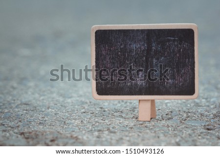 Mini blackboard with easel wooden on floor.