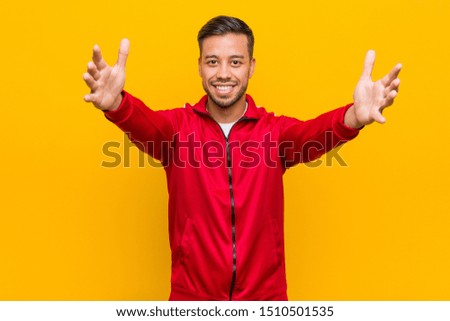 Young filipino fitness man feels confident giving a hug to the camera.