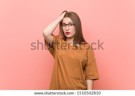 Young student woman wearing eyeglasses tired and very sleepy keeping hand on head.