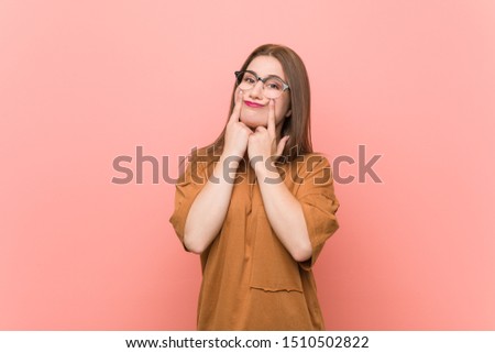 Young student woman wearing eyeglasses doubting between two options.