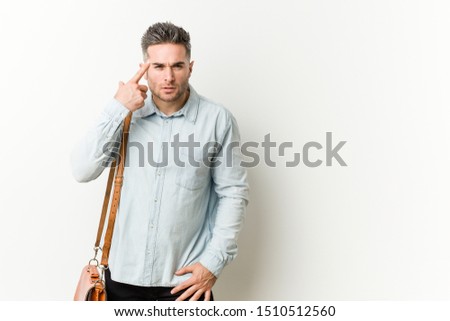 Young handsome business man showing a disappointment gesture with forefinger.