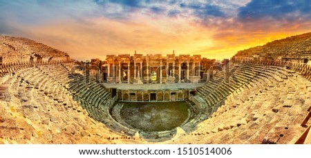 Amphitheater in ancient city of the Hierapolis. Dramatic sunset sky. Unesco Cultural Heritage Monument. Pamukkale, Turkey Royalty-Free Stock Photo #1510514006