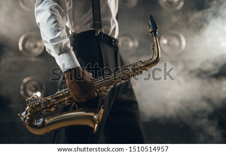 Black jazz musician with saxophone on the stage
