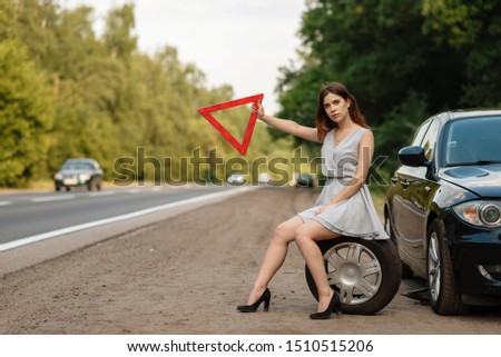 Woman with emergency stop sign vote on the road