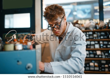 Strange scientist holds screwdriver at his temple